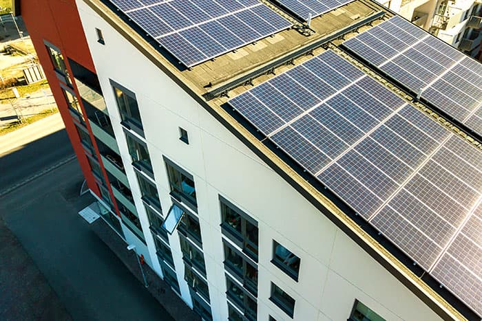 Aerial view of solar panels covering multi-family roofs